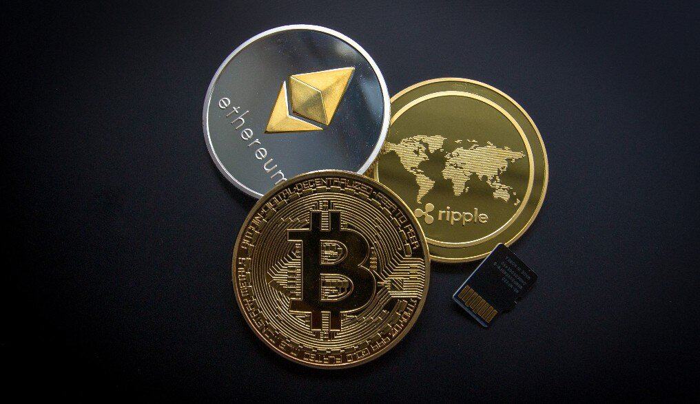 Coins representing Bitcoing, Ethereum, and Ripple