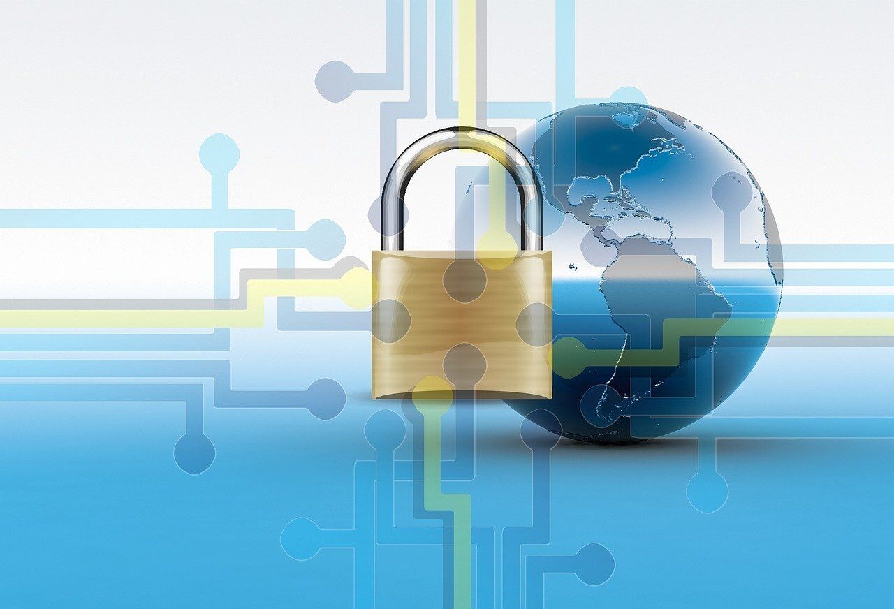 Cybersecurity image featuring lock and globe with circuits superimposed over them